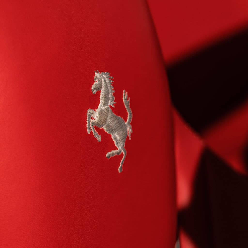 Prancing horse embroidery on a red Ferrari leather seat