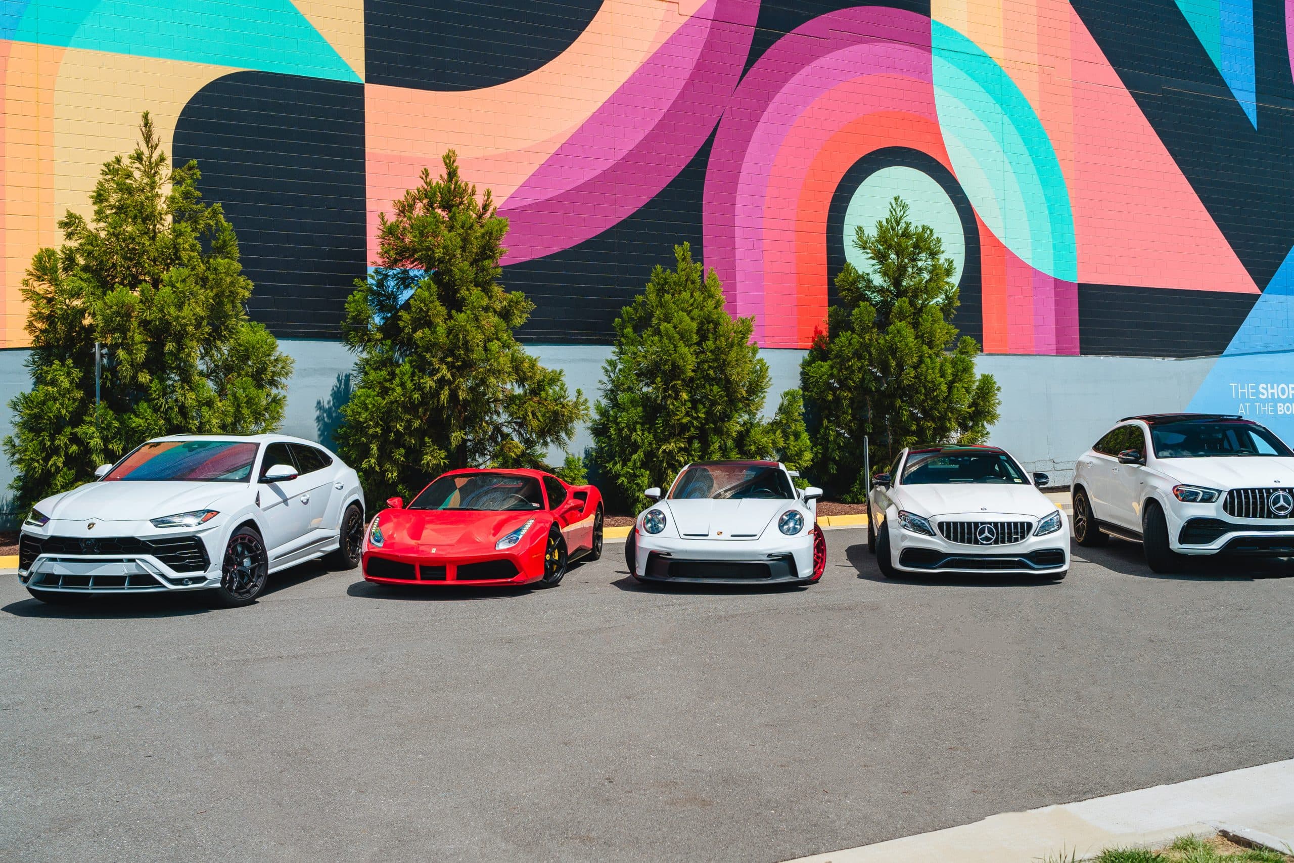 Lamborghini Urus, Ferrari, Porsche 911 GT3 and Mercedes-AMG rental fleet parked in Washington DC